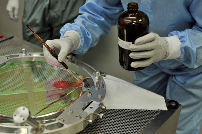 Adding an adhesive layer to protect an optical element of Virgo